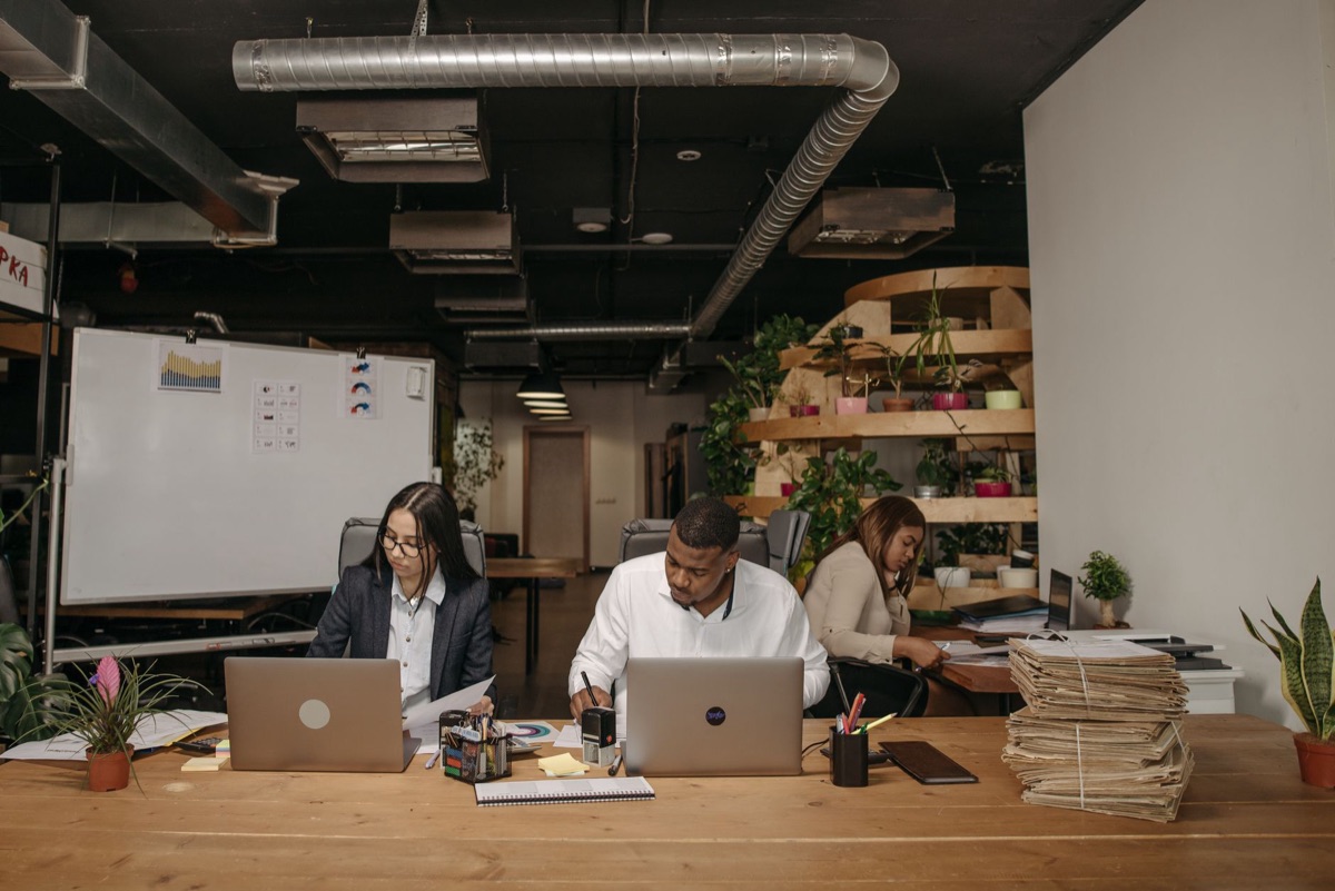 AI startup team in modern office with whiteboards and technical notes