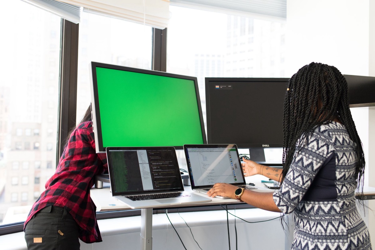 engineers working on computer screens in a tech startup environment