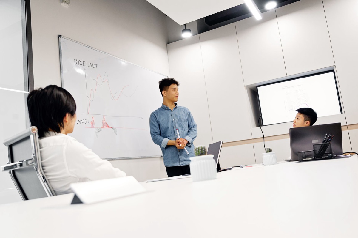 AI startup office with whiteboards and laptops