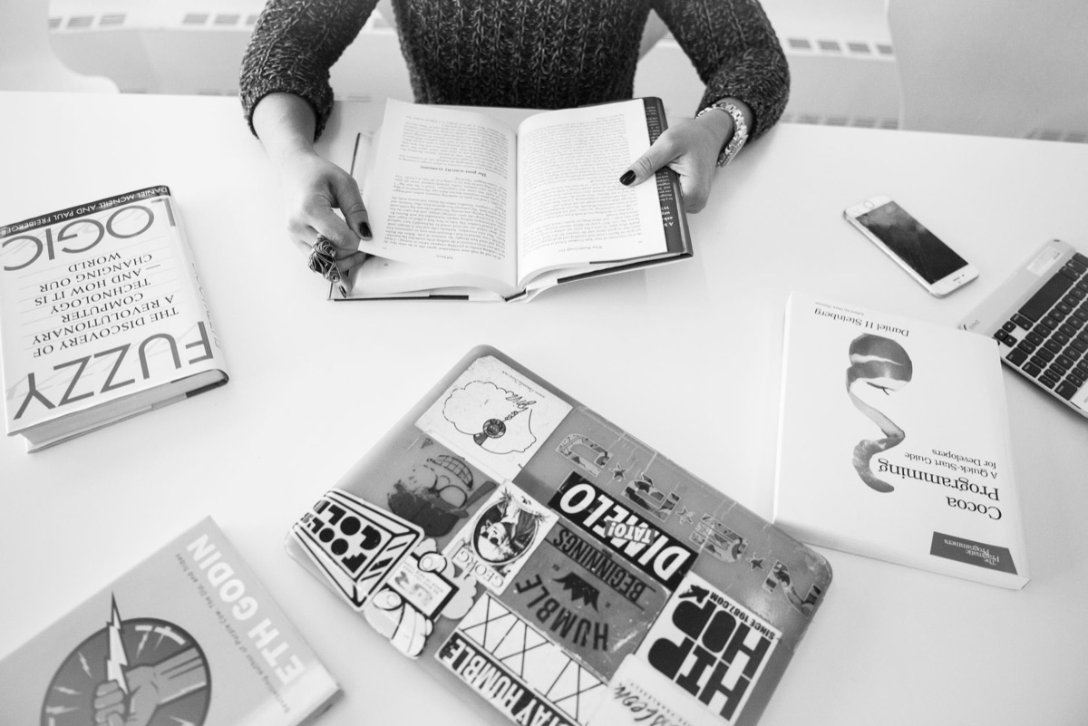 Scientist working at desk with computer and books
