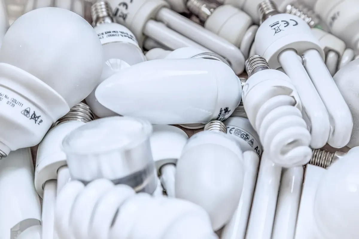 Pile of diverse energy-efficient light bulbs showcasing an array of designs and functionalities.